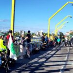 a partyciparade of cyclists protesting and celebrating the people who are part of the solution