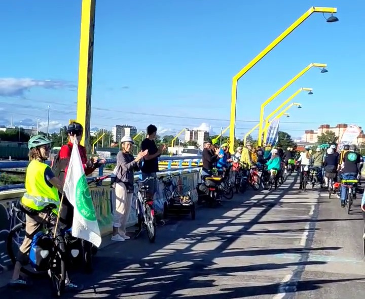 a partyciparade of cyclists protesting and celebrating the people who are part of the solution